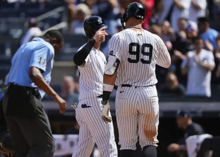 New York Yankees’ Aaron Judge (99) celebrates with Cody Bellinger (35) after hitting a two run home run during the ninth inning of a baseball game against the Chicago Cubs, Saturday, July 12, 2025, in New York.