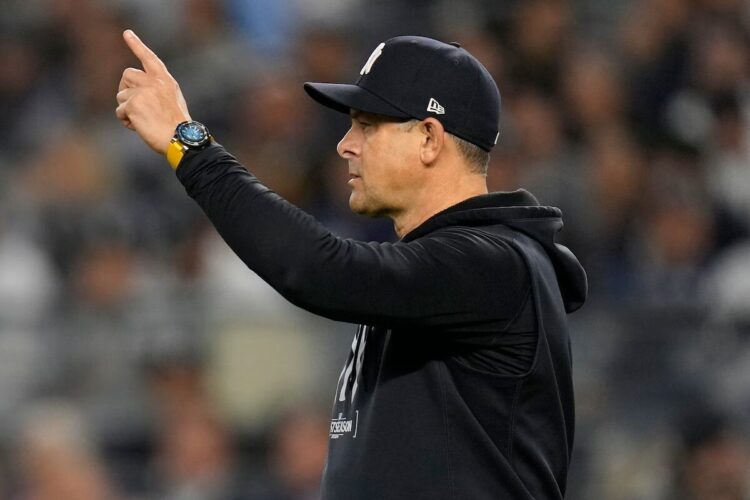 Yankees manager Aaron Boone motions to the bullpen during the sixth inning of Game 2 of the American League baseball playoff series against the Kansas City Royals, Monday, Oct. 7, 2024, in New York.