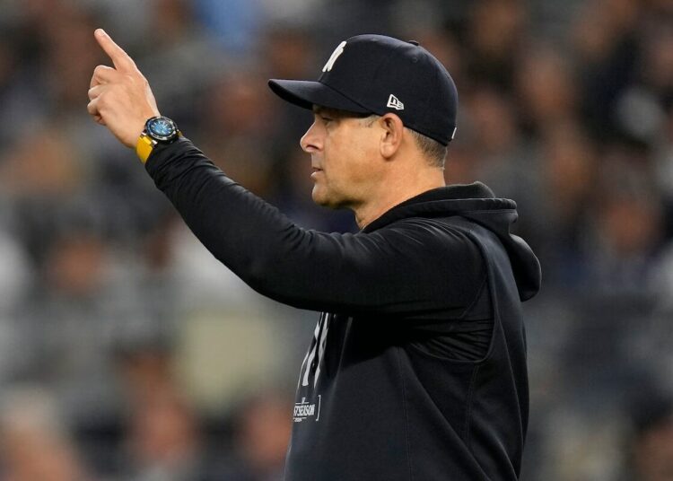 Yankees manager Aaron Boone motions to the bullpen during the sixth inning of Game 2 of the American League baseball playoff series against the Kansas City Royals, Monday, Oct. 7, 2024, in New York.
