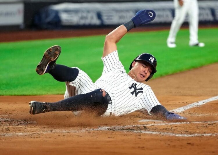 New York Yankees’ Anthony Volpe slides into home base against the Seattle Mariners, July 10, 2025, in New York.
