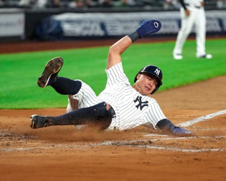 New York Yankees’ Anthony Volpe slides into home base against the Seattle Mariners, July 10, 2025, in New York.