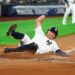New York Yankees’ Anthony Volpe slides into home base against the Seattle Mariners, July 10, 2025, in New York.