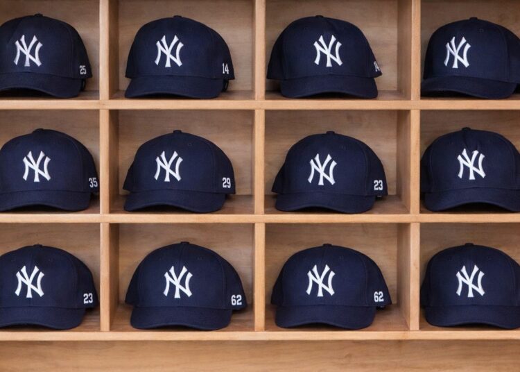 Rows of New York Yankees caps at a merchandise store in Japan.