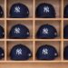 Rows of New York Yankees caps at a merchandise store in Japan.