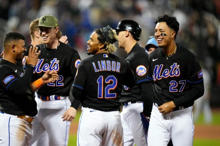 Francisco Lindor (c.) celebrates with teammates after hitting a walkoff RBI-single on Friday night.