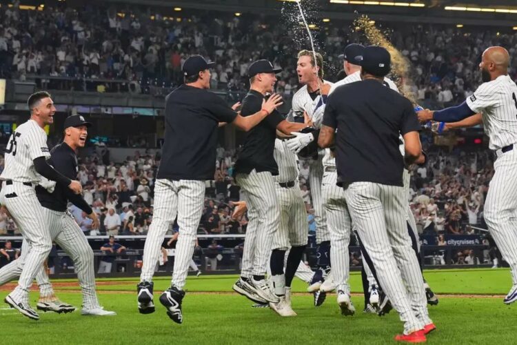 New York Yankees’ Ryan McMahon celebrates with teammates after hitting a walk-off RBI single during the 11th inning of a baseball game against the Tampa Bay Rays Wednesday, July 30, 2025, in New York.