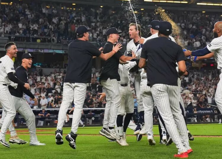 New York Yankees’ Ryan McMahon celebrates with teammates after hitting a walk-off RBI single during the 11th inning of a baseball game against the Tampa Bay Rays Wednesday, July 30, 2025, in New York.