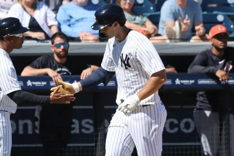 Spencer Jones slaps hands with third base/outfield coach Luis Rojas as he runs around the bases after hitting a solo homer in the second inning of the Yankees’ spring training blowout win over the Cardinals.