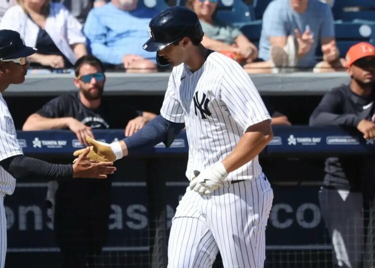 Spencer Jones slaps hands with third base/outfield coach Luis Rojas as he runs around the bases after hitting a solo homer in the second inning of the Yankees’ spring training blowout win over the Cardinals.