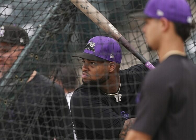 Colorado Rockies outfielder Yanquiel Fernández warms up before a baseball game against the Houston Astros, Tuesday, July 1, 2025, in Denver.