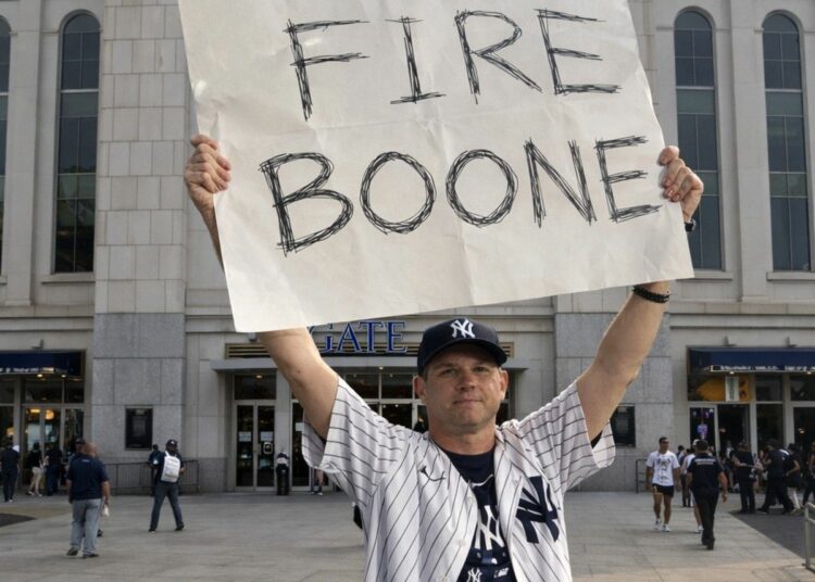 An undated image of a Yankees fan seeking dimissal of manager Aaron Boone in 2025.