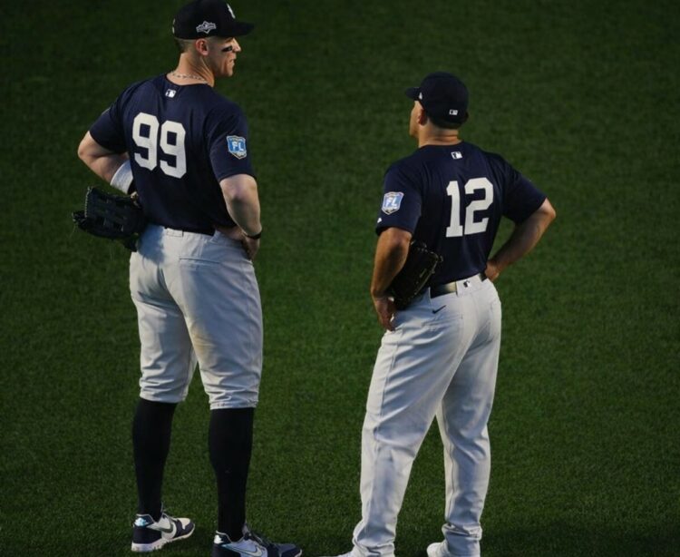Yankees captain Aaron Judge is with Trent Grisham during a March 2026 Spring Training game.