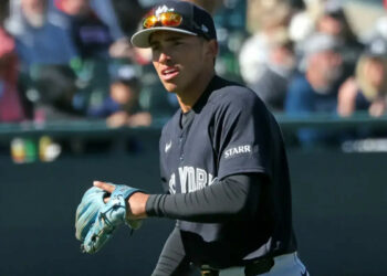 Yankees shortstop George Lombard Jr. throwing before a spring training game.