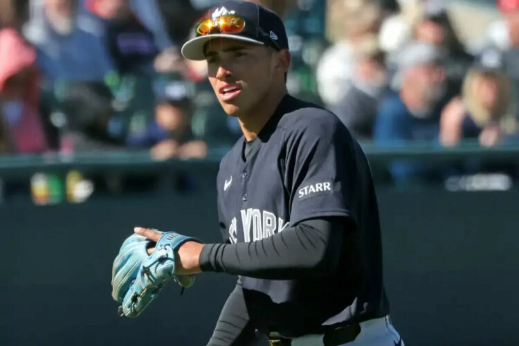 Yankees shortstop George Lombard Jr. throwing before a spring training game.