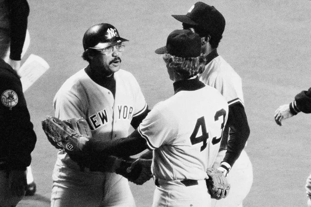 Yankees’ Reggie Jackson, center, who hit a three-run home run, and Ken Clay, who pitched more than three innings without giving up a hit, congratulate each other as New York won the American League playoff opener over Kansas City, Oct. 3, 1978.