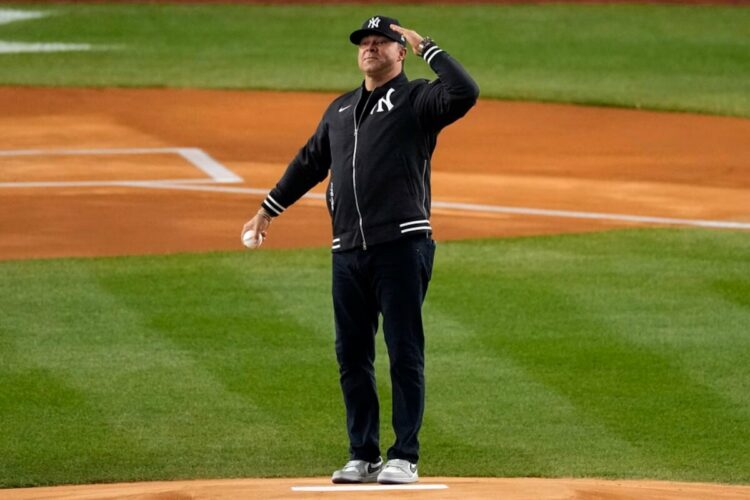 Former New York Yankees' Nick Swisher salutes the crowd before throwing out the ceremonial first pitch before Game 2 of the baseball AL Championship Series between the Cleveland Guardians and New York Yankees Tuesday, Oct. 15, 2024, in New York.