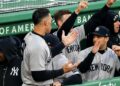 Aaron Judge celebrates in Yankees' dugout after Stanton's homer during the 4-0 win over the Red Sox in Boston, Apr. 21, 2026.