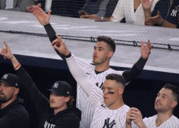Yankees stars in the dugoutt react as Trent Grisham's home run gave them a lead in the 11-10 win over the Angels in New York, Apr. 13, 2026.