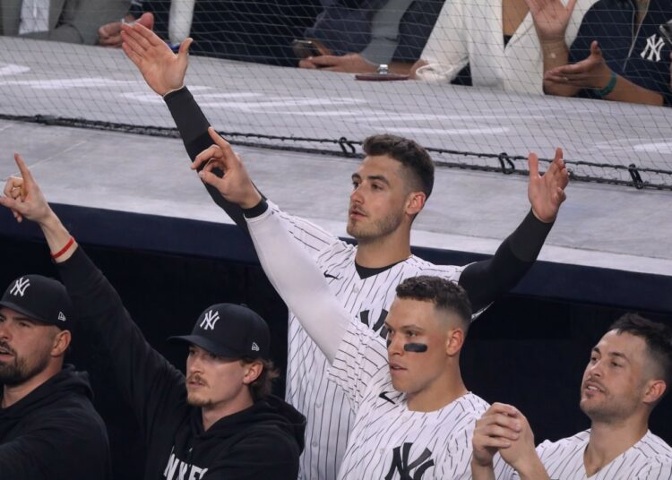 Yankees stars in the dugoutt react as Trent Grisham's home run gave them a lead in the 11-10 win over the Angels in New York, Apr. 13, 2026.