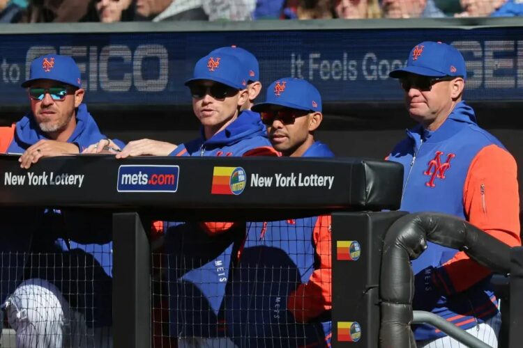 Mets manager Carlos Mendoza (64) in the dugout.