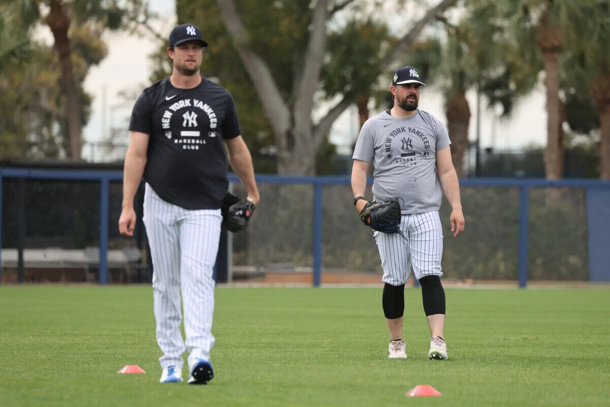 Yankees pitcher Gerrit Cole #45, (left) and New York Yankees pitcher Carlos Rodón #55, throwing on a back field as pitchers and catchers reported to Spring Training.
