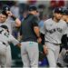 New York Yankees starting pitcher Elmer Rodriguez, right front, walks to the dugout after turning the ball over to manager Aaron Boone, center left, as José Caballero (72), Ben Rice, left rear, and J.C. Escarra, right rear, stand on the mound in the fifth inning of a baseball game against the Texas Rangers Wednesday, April 29, 2026, in Arlington, Texas.