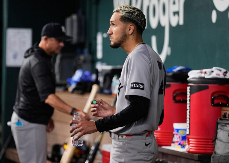New York Yankees starting pitcher Elmer Rodriguez stands in the dugout after being pulled in the fifth inning of a baseball game against the Texas Rangers Wednesday, April 29, 2026, in Arlington, Texas.