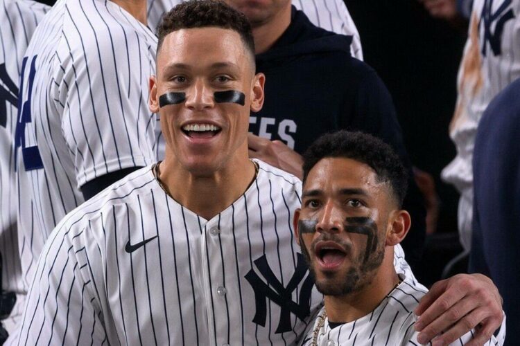 Aaron Judge celebrates with Jose Caballero after his walk-off double capped a wild 5-4 Yankees win over the Angels in New York, Apr. 15, 2026.