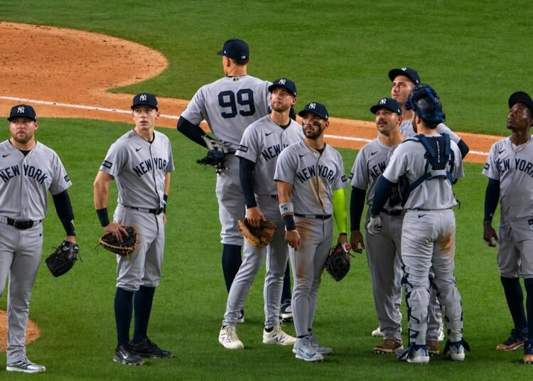 The Yankees players are looking at a replay during the 3-2 nail-biter win over the Rangers in Texas on Apr. 28, 2026.
