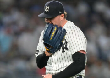 New York Yankees pitcher Ryan Weathers yells into his glove as he walks to dugout during the second inning of a baseball game against the Los Angeles Angels, Tuesday, April 14, 2026, in New York.
