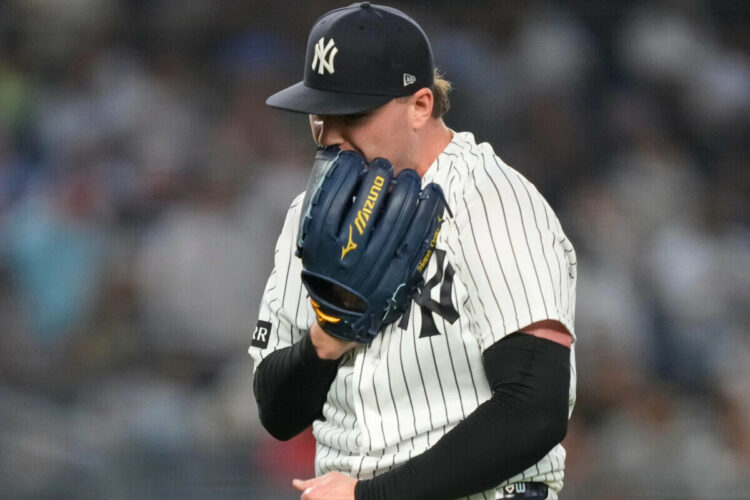 New York Yankees pitcher Ryan Weathers yells into his glove as he walks to dugout during the second inning of a baseball game against the Los Angeles Angels, Tuesday, April 14, 2026, in New York.