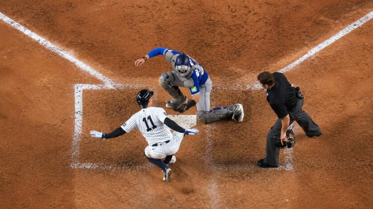 Anthony Volpe avoids tagging at home plate to score a run in the Yankees' 7-6 win over the Blue Jays, New York, May 18, 2025.