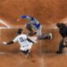 Anthony Volpe avoids tagging at home plate to score a run in the Yankees' 7-6 win over the Blue Jays, New York, May 18, 2025.