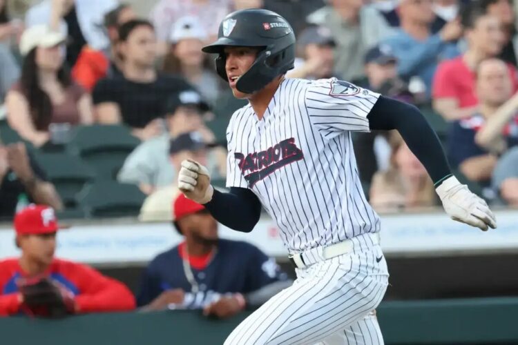 Somerset Patriots shortstop George Lombard Jr. scores during a game against the Reading Fightin’ Phils.