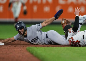 New York Yankees’ José Caballero, left, is caught by Baltimore Orioles second baseman Blaze Alexander, right, while trying to steal second base during the ninth inning of a baseball game, Monday, May 11, 2026, in Baltimore.