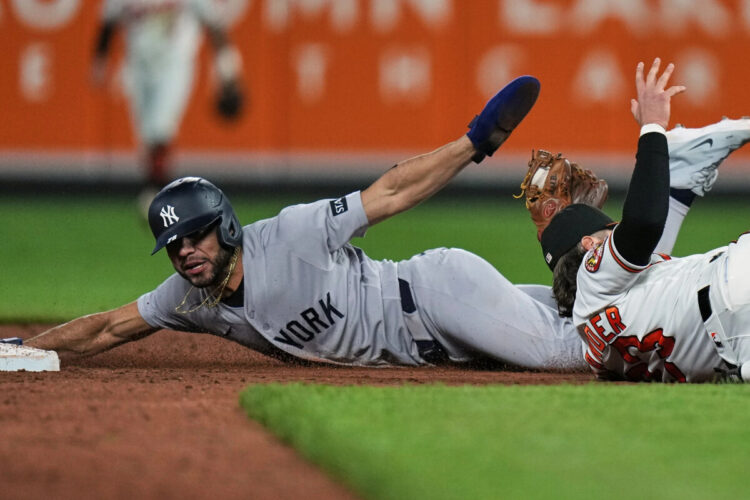 New York Yankees’ José Caballero, left, is caught by Baltimore Orioles second baseman Blaze Alexander, right, while trying to steal second base during the ninth inning of a baseball game, Monday, May 11, 2026, in Baltimore.