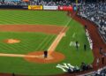 Michael Kay and Suzanne Welderman are paying tribute to legendary Yankees voice John Sterling at Yankee Stadium, May 4, 2026. Sterling died at 87 in the morning.