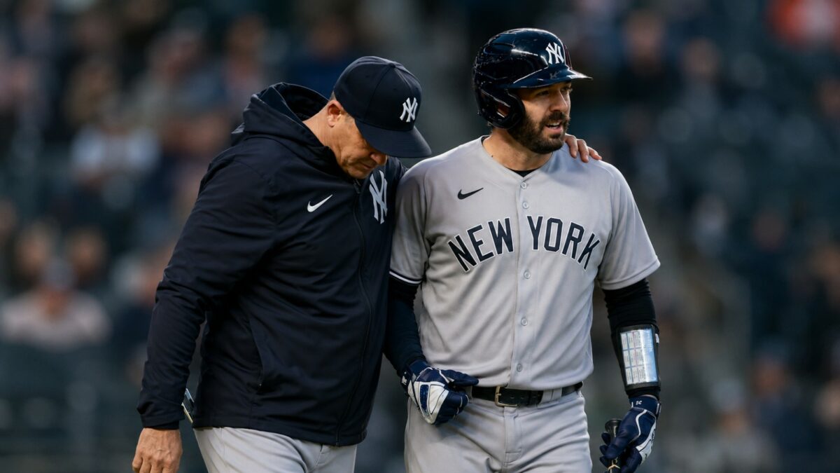 Yankees manager Aaron Boone and catcher Austin Wells together after an on-road win in April, 2026.
