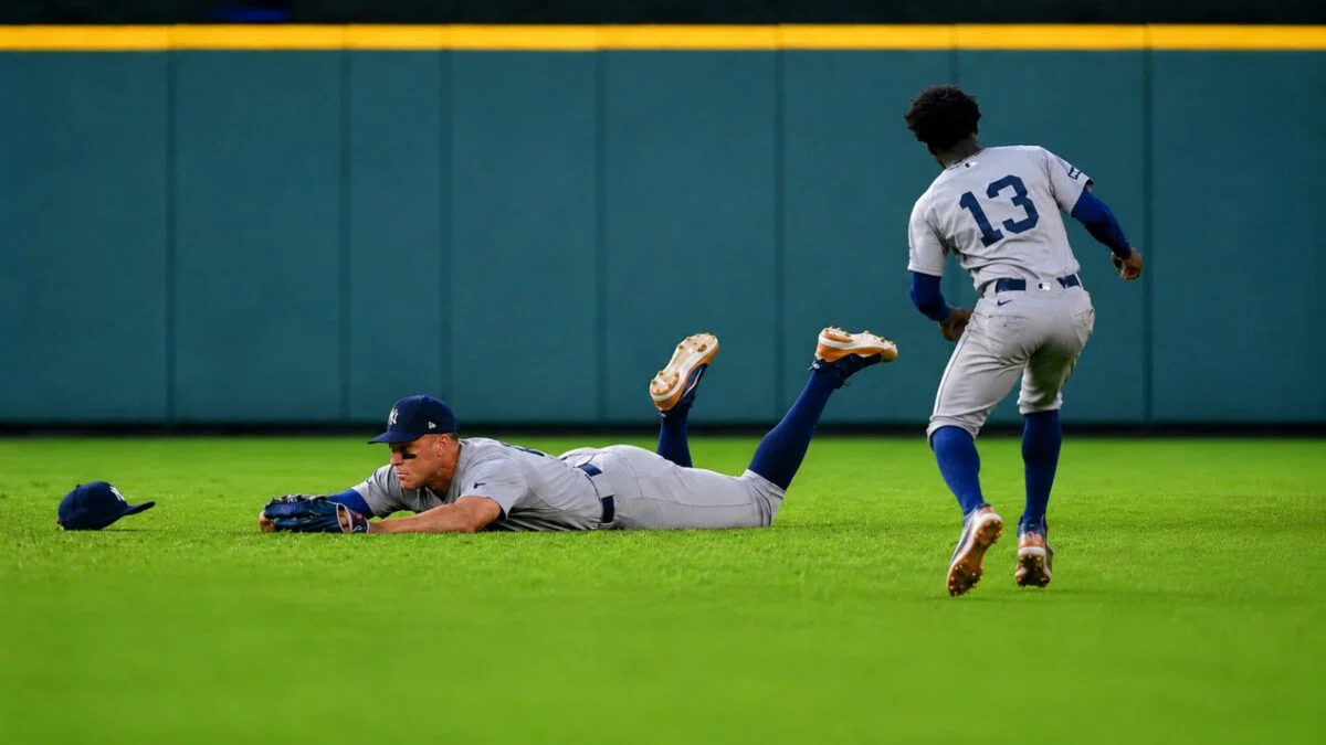 Aaron Judge dives to avoid getting in the way of Jazz Chisholm's catch on April 26, 2026 in Houston, Texas.