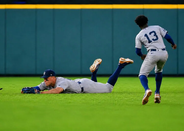Aaron Judge dives to avoid getting in the way of Jazz Chisholm's catch on April 26, 2026 in Houston, Texas.