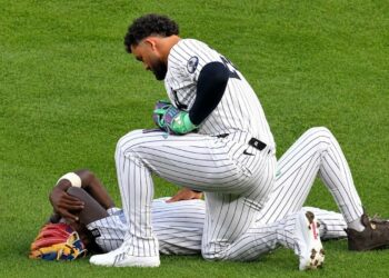 Jasson Dominguez check with Jazz Chisholm Jr. after a collision left him injured during the Yankees' 7-2 loss to the Tigers in New York, Jun 30, 2026.