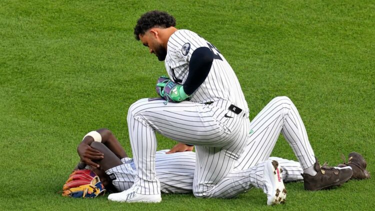 Jasson Dominguez check with Jazz Chisholm Jr. after a collision left him injured during the Yankees' 7-2 loss to the Tigers in New York, Jun 30, 2026.