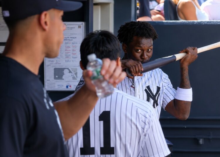 Aaron Judge looks at as Jazz Chisholm kisses his bat in the dugout during the Yankees' 6-1 rout of the Red Sox in New York, June 7, 2026.
