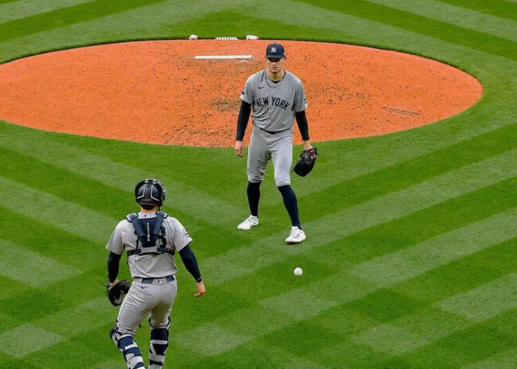 The ball fell between Cam Schlittler and Austin Wells in the second in the Yankees' 6-3 loss to the Red Sox, Boston, Jun 26, 2026.