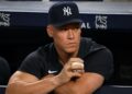 Aaron Judge watches from the dugout during the Yankees' 8-5 win over the Pirates, New York, July 20, 2026.