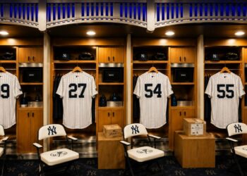 An image of the Yankees clubhouse at New York's Yankee Stadium with Judge, Fried, Rodon, and Stanton jerseys, 2026.