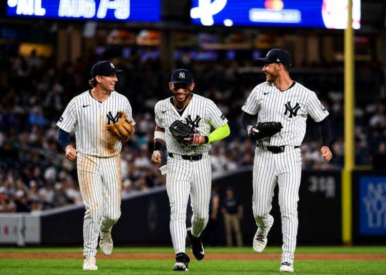 Ryan McMahon, Jose Caballero, and Cody Bellinger celebrate after the Yankees' 5-2 win over the Twins in New York, July 3, 2026.
