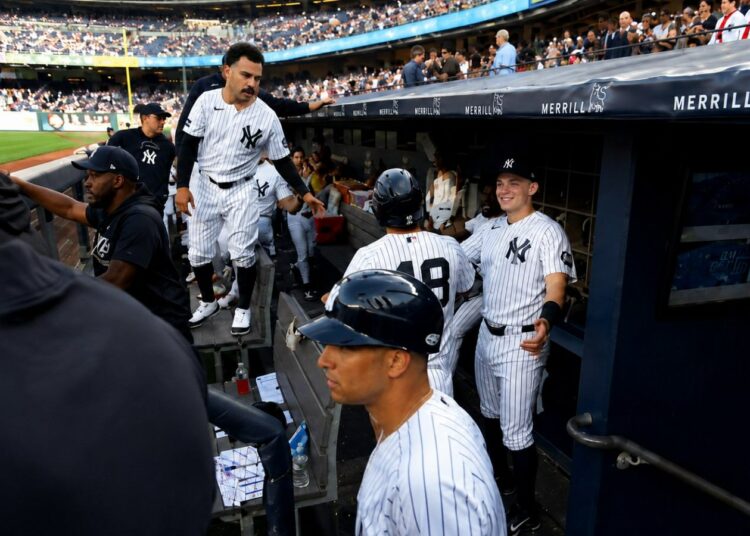 Trent Grisham and Ben Rice congratulate Goldschmidt after second run in the Yankees' 8-2 loss to the Dodgers in New York, July 19, 2026.