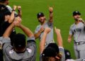 Manager Aaron Boone and coaches celebrated with fans after the Yankees' 5-3 win over the Orioles, Baltimore, August 19, 2026.