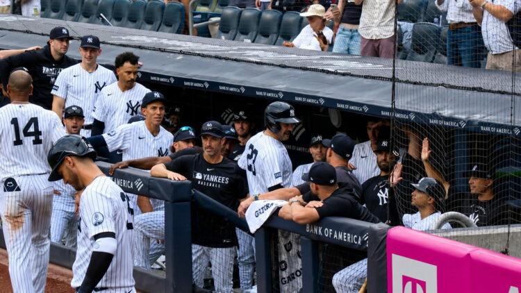 Pinch hitter Austin Wells gets hugs in the dugout after his second home run in the Yankees' 16-1 win over the Red Sox, New York, August 30, 2026.
